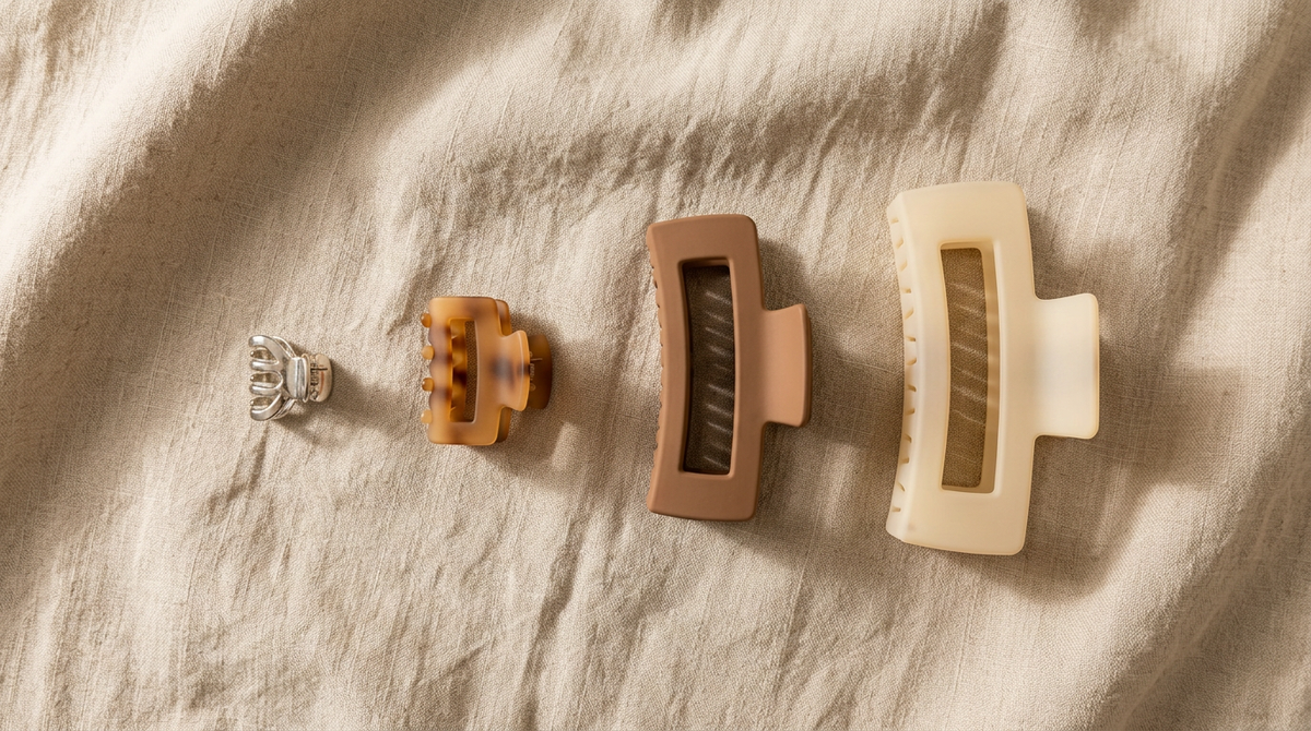 Four claw clips lined up from mini metal to extra-large matte to compare sizes